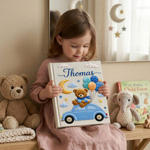 Personalized hand embroidered baby photo album featuring teddy bear on vintage blue car with balloons, moon, stars, and custom name embroidery